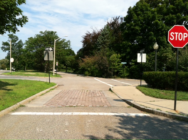 The STOP sign on the Carriage Road was before these cobbles, which were purely decorative., as there was and is no crosswalk here. The STOP sign was too far from the intersection to be helpful in preventing crashes beteween WB motor vehicle traffic and N/S vehicular traffic.